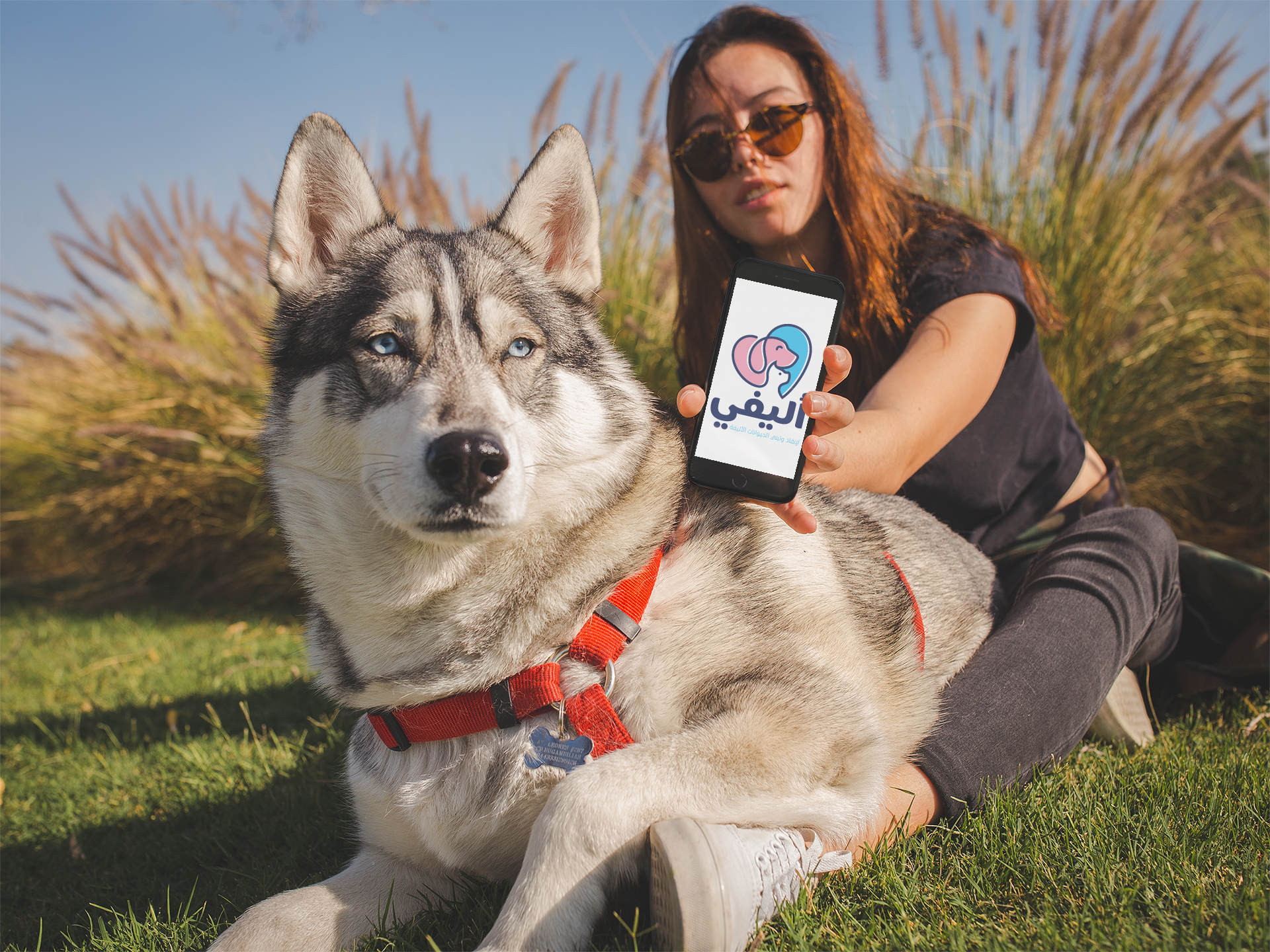 pretty-woman-showing-an-app-on-her-iphone-mockup-above-her-dog-a19636