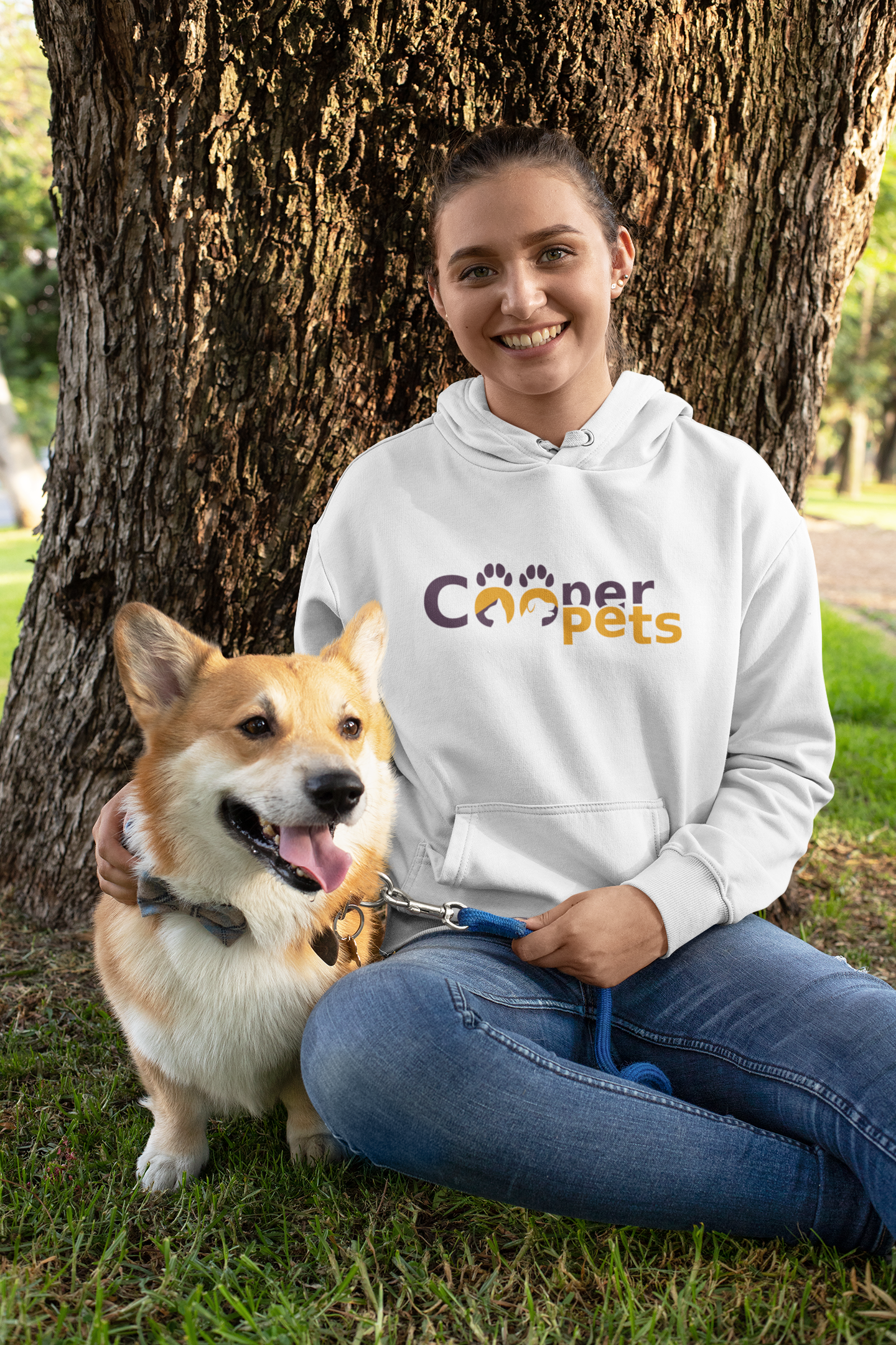 pullover-hoodie-mockup-featuring-a-woman-and-her-dog-sitting-by-a-tree-28040