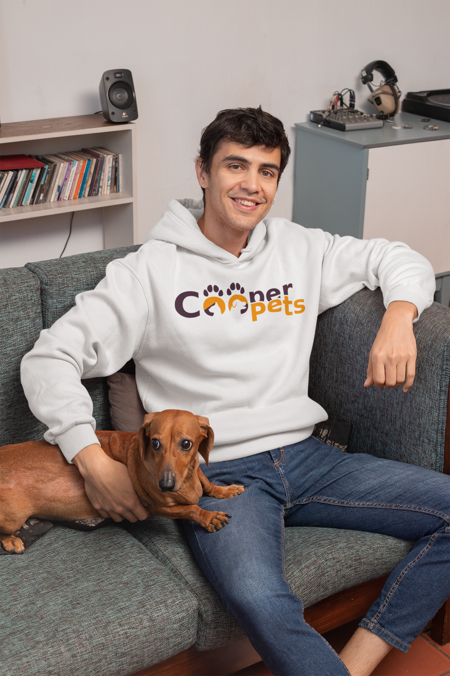 pullover-hoodie-mockup-featuring-a-young-man-sitting-on-a-couch-with-his-dog-30681